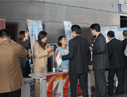 The attendees are visiting the exhibition booth
