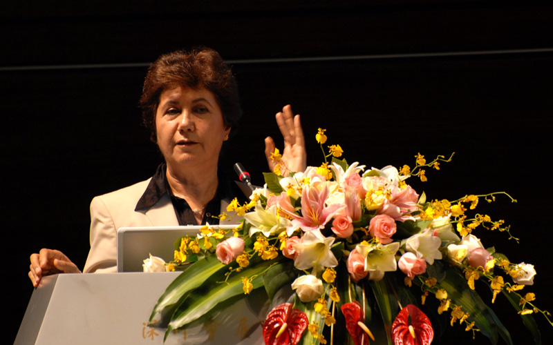 Ms. Mahin Faghfouri, President of IMMTA, is giving a speech